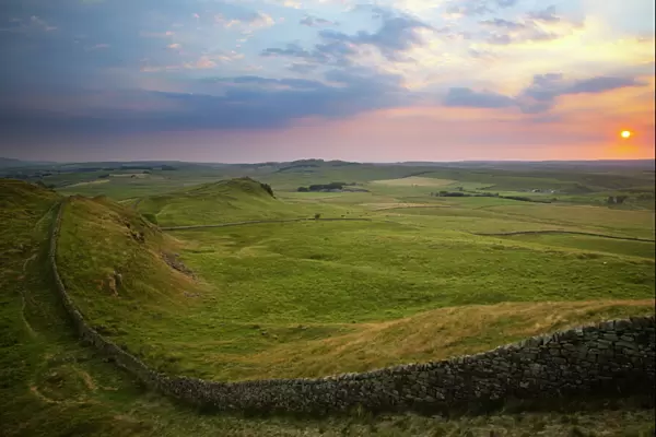 ENGLAND Northumberland Hadrians Wall Sunset behind the world heritage site of Hadrians Wall near the town of