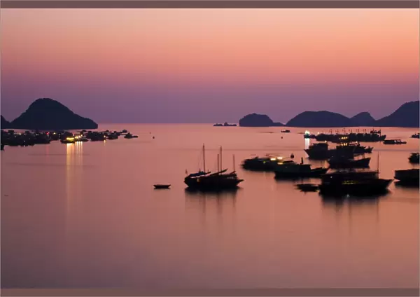 Vietnam, Northern Vietnam, Halong Bay. The pink sunset afterglow at dusk over Cat Ba harbour on Cat Ba