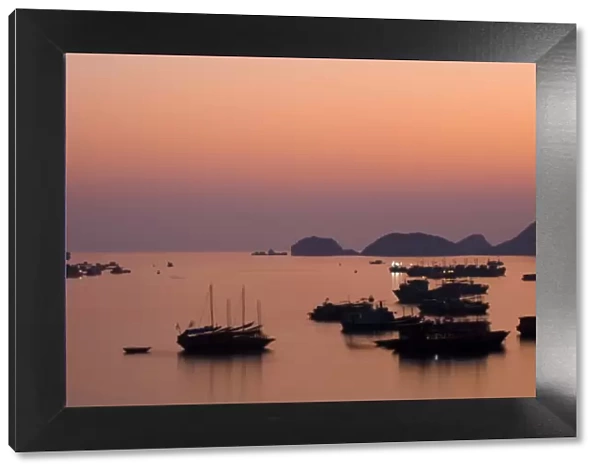Vietnam, Northern Vietnam, Halong Bay. The pink sunset afterglow at dusk over Cat Ba harbour on Cat Ba