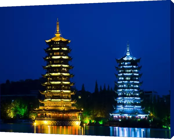 China, Guangxi Zhuang Autonomous Region, Guilin City. Illuminated Pagodas at dusk