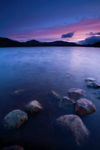 Scotland, Scottish Highlands, Cairngorms National Park. Deep red clouds above Loch Morlich