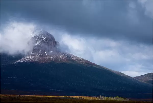 Australia, Tasmania, Cradle Mt - Lake St Clair National Park. Dramatic storm clouds clear revealing Mount Pelion West - Viewed from the