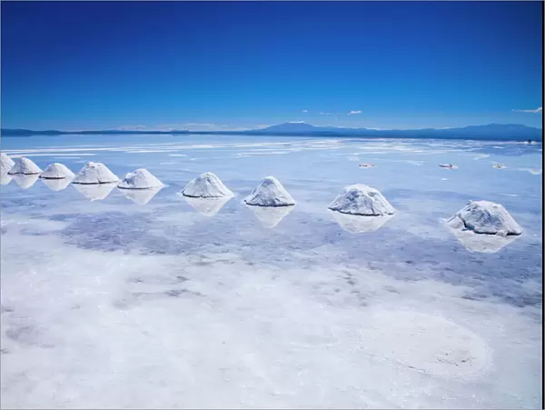 Bolivia, Southern Altiplano, Salar de Uyuni. Cones of salt stacked on the Salar de Uyuni salt flat
