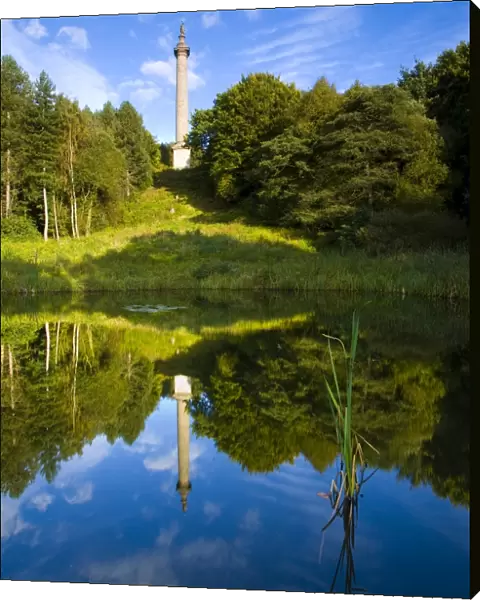 The column of liberty reflected in a pool forming part of the 18th-century landscaped forest