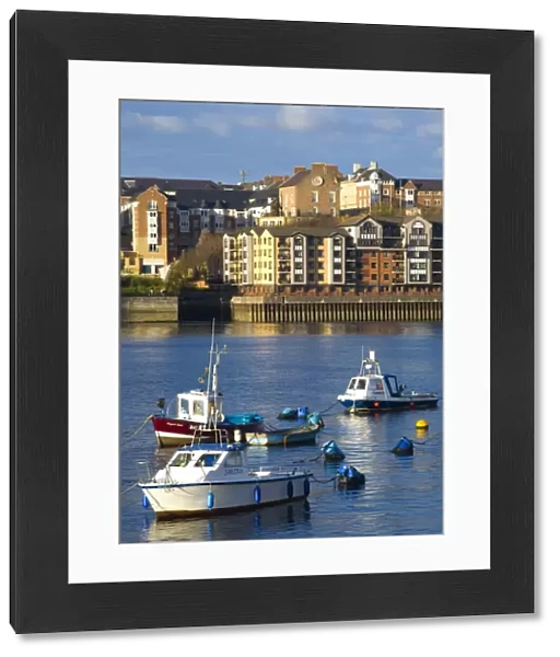 England, Tyne & Wear, North Shields. Boats moored on the River Tyne with a complex of new apartments located on the North Shields Quayside in
