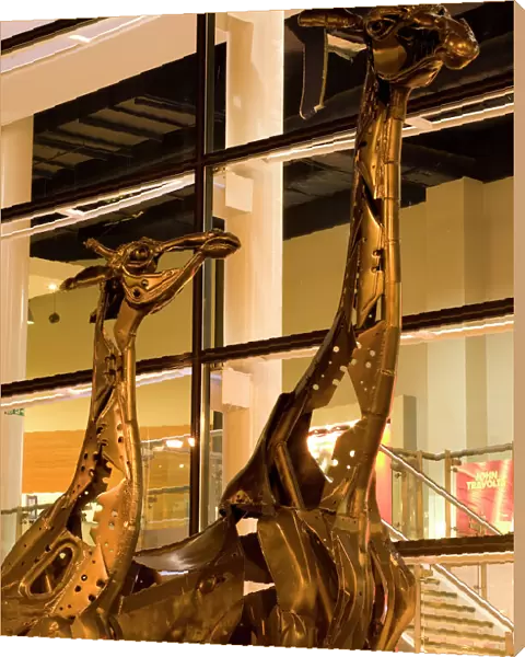 Scotland, Edinburgh, Omni Centre. These two giraffes that stand proud outside the Omni situated at Greenside Place, were created entirely out of scrap metal. They were titled Dreaming Spires by their designer