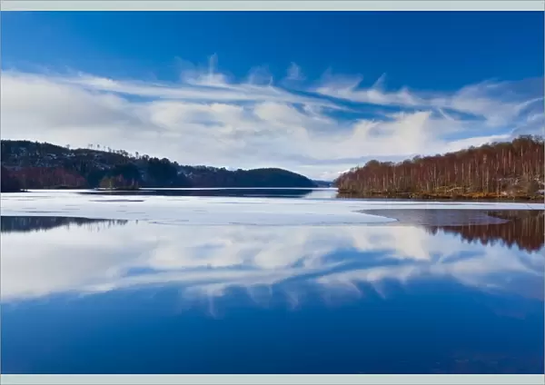 Scotland, Scottish Highlands, Loch Garry. Cloud formations reflected upon the mirror like face of Loch