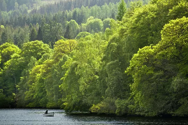 Scotland, Perth and Kinross, Pitlochry. Fishing from a boat on Loch Faskally