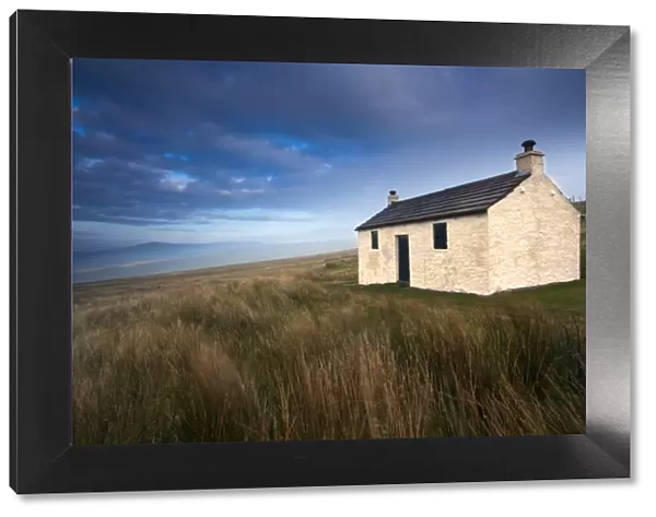 England, Cumbria, North Pennines. A small cottage located within the barren landscape of Hartside Pass near Alston within the North Pennines Area of Outstanding Natural