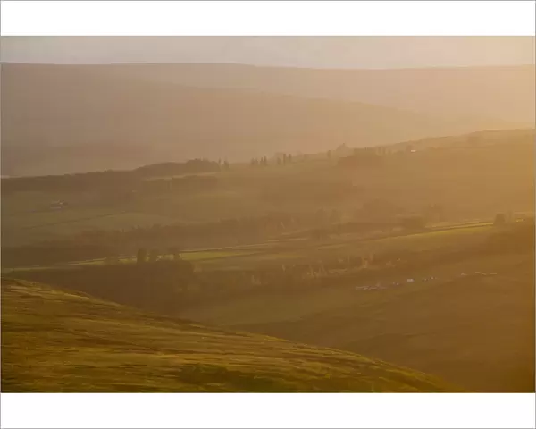 England, County Durham, Weardale. Hazy sunset over the hills of the Northern Pennines