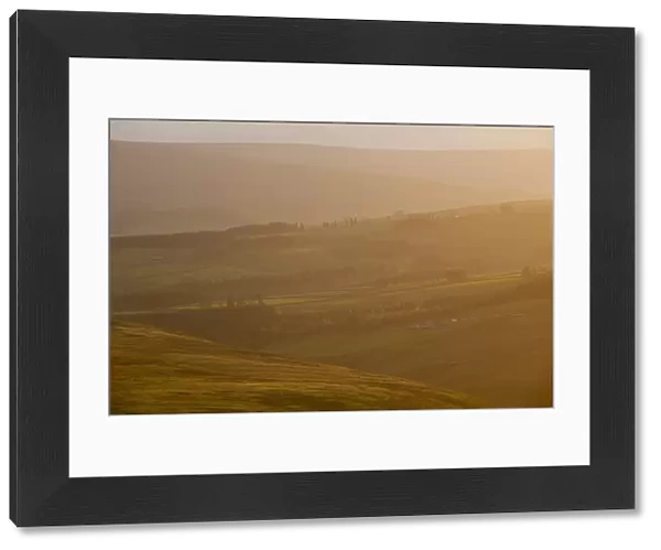 England, County Durham, Weardale. Hazy sunset over the hills of the Northern Pennines