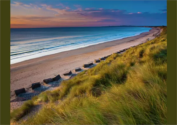 England, Northumberland, Druridge Bay. A dramatic expanse of sand dunes fringing the picturesque beach at Druridge Bay, viwed shortly
