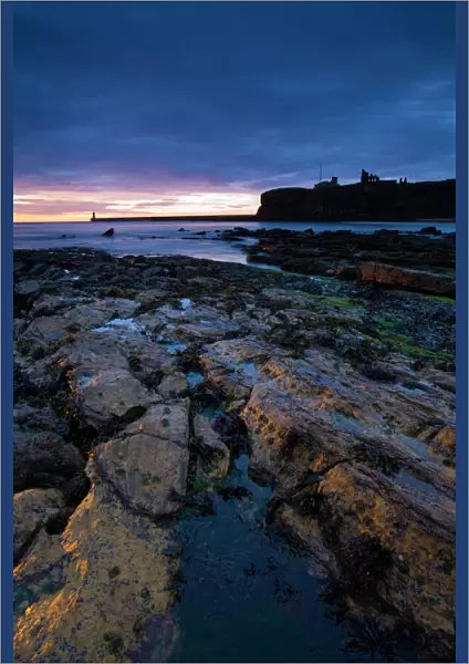 Sunrise over King Edwards Bay viewed from near Sharpness Point. The remains of Tynemouth Priory can be seen to