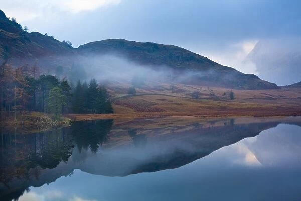 England, Cumbria, The Lake District. A misty dawn at Blea Tarn near Great Langdale