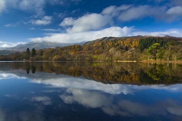 England, Cumbria, Lake District National Park. Lakeland hills reflected upon the still face of Coniston