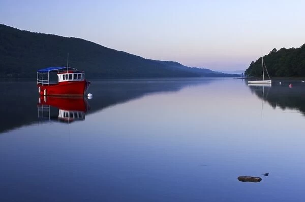 England, Cumbria, Lake District National Park. Dawn looking across the still waters