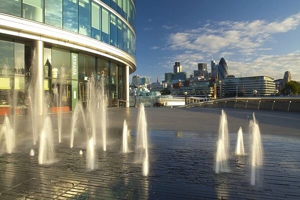 England, London, Southwark. Water fountains near the London City Hall and the More London develpoment, looking towards the financial district of the City of London and