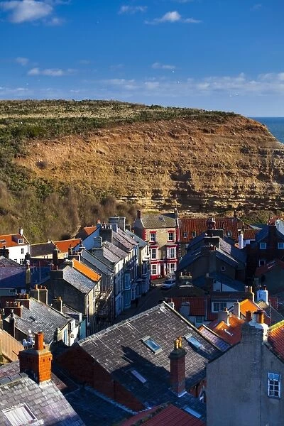 England, North Yorkshire, Staithes. View looking down on the roofs and chimney pots of the old town of Staithes, located within the North York Moors