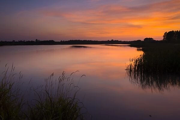 England, Tyne and Wear, Big Waters County Park. Sunset over the lake in Big Waters Country Park The lake is a a subsidence pond, formed by the collapse of old