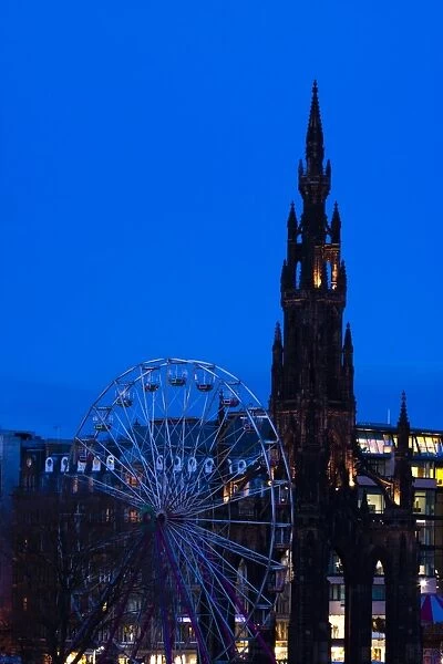Scotland, Edinburgh, Princes Street. Ferris Wheel alongside the Monument to Sir Walter Scott