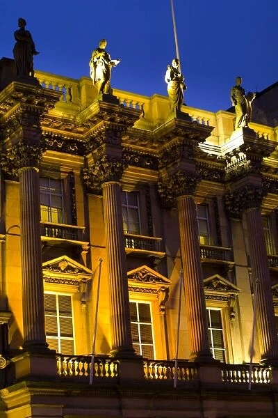 Scotland, Edinburgh, St Andrews Square. Statutes situated on a flood lit building in St Andrew s