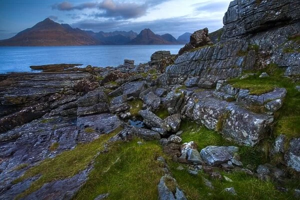 Scotland, Isle Of Skye, Elgol. Looking across the rocky shoreline north of Elgol towards the peaks of the