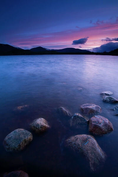 Scotland, Scottish Highlands, Cairngorms National Park. Deep red clouds above Loch Morlich