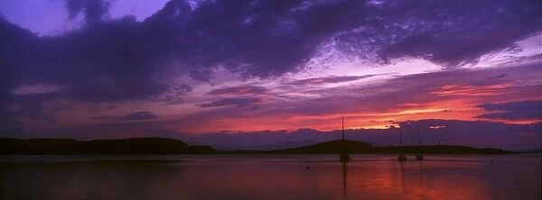 SCOTLAND, Scottish highlands, Oban. The pinks and reds of a west coast sunset looking towards the western