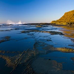 Australia, New South Wales, Royal National Park. Early morning light gently illuminates the picturesque coastline found at North Era, on the Royal National Park