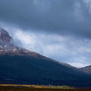 Australia, Tasmania, Cradle Mt - Lake St Clair National Park. Dramatic storm clouds clear revealing Mount Pelion West - Viewed from the
