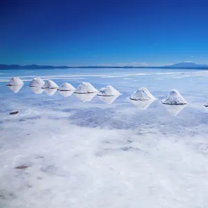 Bolivia, Southern Altiplano, Salar de Uyuni. Cones of salt stacked on the Salar de Uyuni salt flat