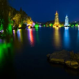 China, Guangxi Zhuang Autonomous Region, Guilin City. Illuminated Pagodas at dusk