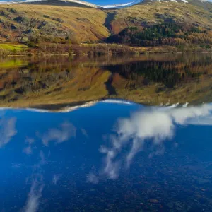 England, Cumbria, Lake District National Park. Lakeland hills reflected upon the still face of the Thirlmere