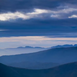 England, Cumbria, Lake District National Park. Mountain fog in the valleys of the western Lake District overlooked by the highest peak