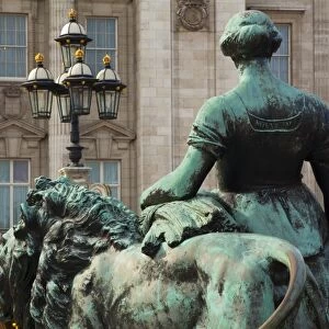 England, Greater London, City of Westminster. Bronze statue on the Victoria Memorial in Queens Garden, looking towards Buckingham Palace in