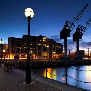 England, Greater Manchester, Salford Quays. Cranes overlooking Ontario Basin part of the recently redeveloped Salford Quays in