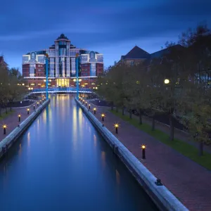 England, Greater Manchester, Salford Quays. Victoria Harbour building beyond Mariners Canal footbridge on the Manchester Ship Canal located