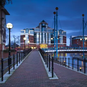 England, Greater Manchester, Salford Quays. Victoria Harbour building beyond Mariners Canal footbridge on the Manchester Ship Canal located