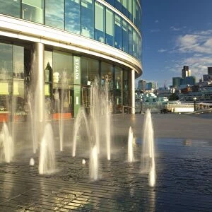 England, London, Southwark. Water fountains near the London City Hall and the More London develpoment, looking towards the financial district of the City of London and