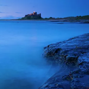 England, Northumberland, Bamburgh. Bamburgh Castle and the North Sea, viewed from Harkess Rocks