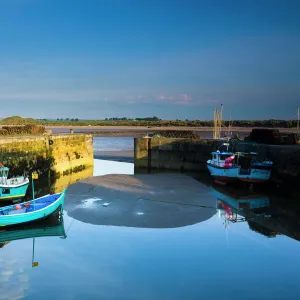 England, Northumberland, Beadnell. Boats moored within the Harbour Walls of the Beadnell Harbour - viewed at