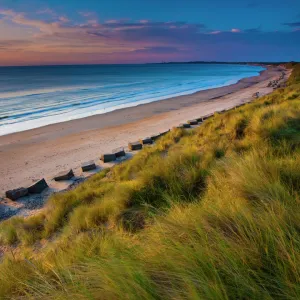 England, Northumberland, Druridge Bay. A dramatic expanse of sand dunes fringing the picturesque beach at Druridge Bay, viwed shortly