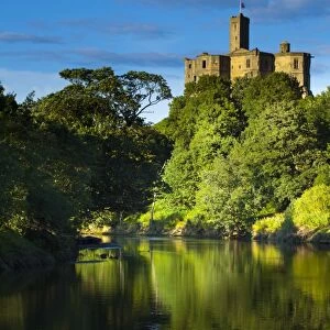 England, Northumberland, Warkworth. Warkworth Castle reflected in the still waters of the River Coquet