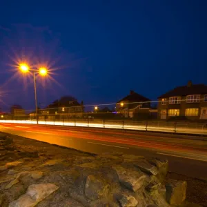 England, Tyne & Wear, Newcastle Upon Tyne. Rush hour traffic alongside Hadrians Wall in East Denton. Hadrians Wall was built to protect Roman Britain from raids by the Picts to the north, and stretched from the Solway Firth to Wallsend