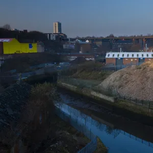 England, Tyne and Wear, Newcastle Upon Tyne. The Ouseburn running through a disappearing industrial landscape. The 800 metre long Byker Viaduct can be seen in