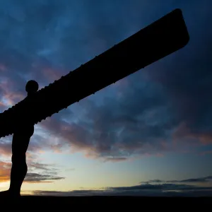 The iconic Angel of the North statue silhouetted against an atmospheric sky