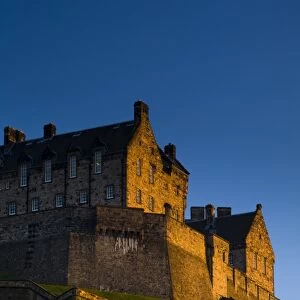 Scotland, Edinburgh, Edinburgh Castle. The last light of the setting sun illuminates Edinburgh Castle
