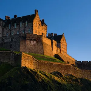 Scotland, Edinburgh, Edinburgh Castle. The last light of the setting sun illuminates Edinburgh Castle