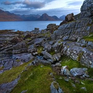 Scotland, Isle Of Skye, Elgol. Looking across the rocky shoreline north of Elgol towards the peaks of the