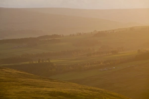 England, County Durham, Weardale. Hazy sunset over the hills of the Northern Pennines England, County Durham, Weardale. Hazy sunset over the hills of the Northern Pennines
